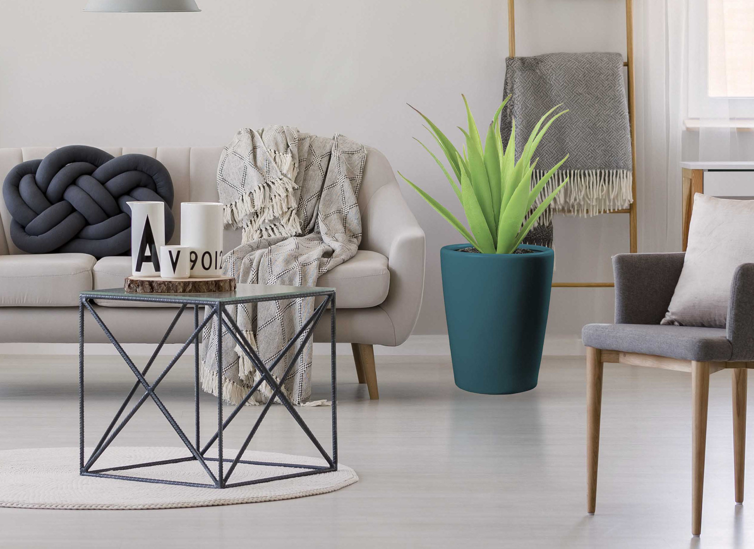 Gray rug, pouf and armchair in spacious floral living room interior with beige settee near dark table